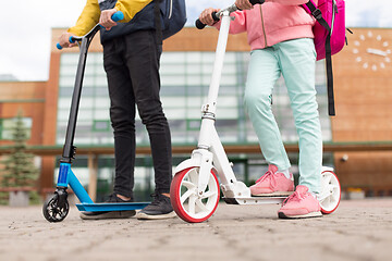 Image showing school children with backpacks and scooters