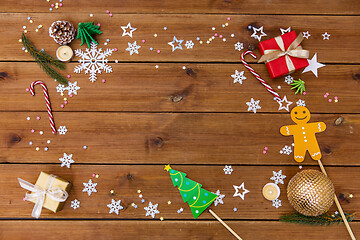 Image showing christmas gifts and decorations on wooden boards