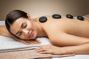 Image showing woman having hot stone massage at spa