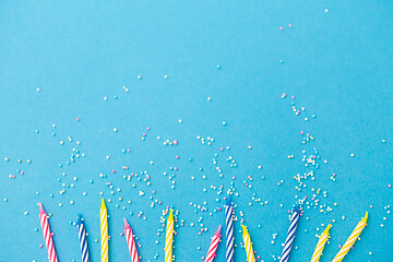 Image showing birthday candles with sprinkles on blue background