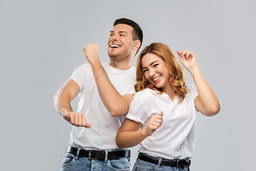 Image showing portrait of happy couple in white t-shirts dancing