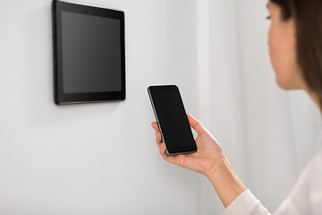 Image showing woman using tablet computer and smartphone