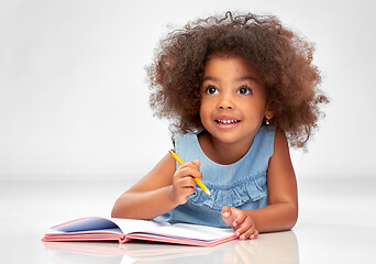 Image showing happy little african american girl with sketchbook