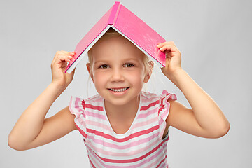 Image showing little girl with roof of book on top of her head