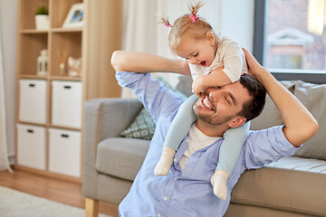 Image showing father riding little baby daughter on neck at home