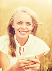 Image showing happy woman with smartphone and earphones