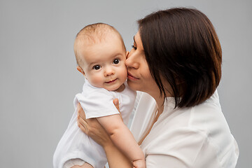 Image showing happy mother kissing little baby daughter