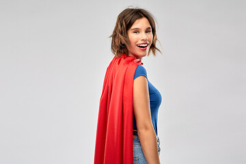 Image showing happy woman in red superhero cape