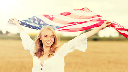 Image showing happy woman with american flag on cereal field