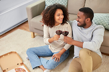 Image showing happy couple with wine and takeaway pizza at home