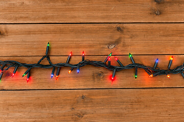 Image showing christmas garland lights on wooden background