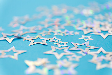 Image showing star shaped confetti decoration on blue background