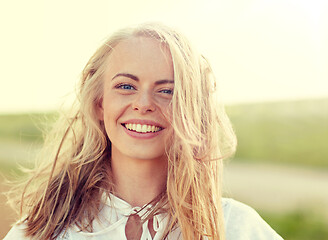 Image showing close up of happy young woman in white outdoors