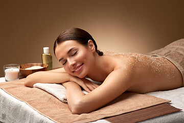 Image showing woman lying with sea salt scrub on skin at spa