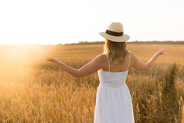 Image showing happy woman in straw hat on cereal field in summer