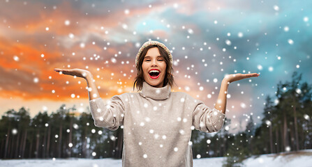 Image showing woman in hat and sweater over winter forest