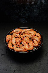 Image showing Boiled big sea prawns or shrimps placed on black ceramic plate