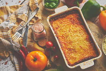 Image showing Tasty traditional italian lasagna with bolognese, melted and cheese. Served with ingredients