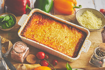 Image showing Tasty traditional italian lasagna with bolognese, melted and cheese. Served with ingredients