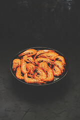 Image showing Boiled big sea prawns or shrimps placed on black ceramic plate