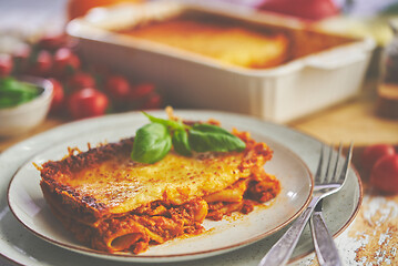 Image showing Tasty traditional italian lasagna with bolognese, melted and cheese. Served with ingredients