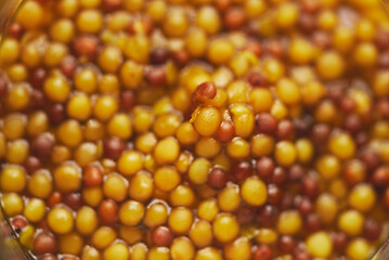 Image showing French mustard with whole seeds served in glass jar. Selective focus