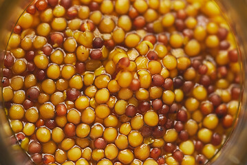 Image showing French mustard with whole seeds served in glass jar. Selective focus