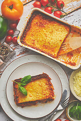 Image showing Tasty traditional italian lasagna with bolognese, melted and cheese. Served with ingredients