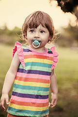 Image showing little girl spending time at backyard