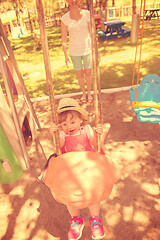 Image showing mother and daughter swinging in the park