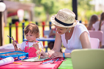 Image showing mom and little daughter drawing a colorful pictures