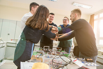 Image showing students celebrating successfully finished project