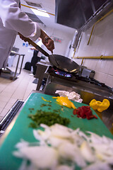 Image showing chef preparing food, frying in wok pan