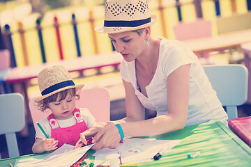 Image showing mom and little daughter drawing a colorful pictures