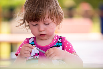 Image showing little girl drawing a colorful pictures