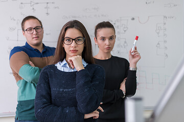 Image showing portrait of young students in front of chalkboard