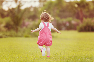 Image showing little girl spending time at backyard