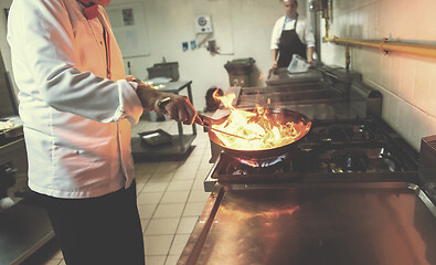 Image showing Chef doing flambe on food