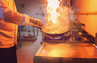 Image showing Chef doing flambe on food