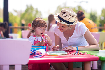 Image showing mom and little daughter drawing a colorful pictures