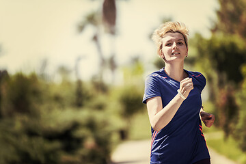 Image showing young female runner training for marathon