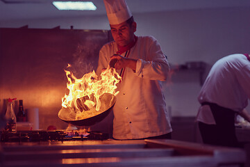 Image showing Chef doing flambe on food