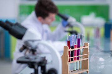 Image showing student scientist looking through a microscope