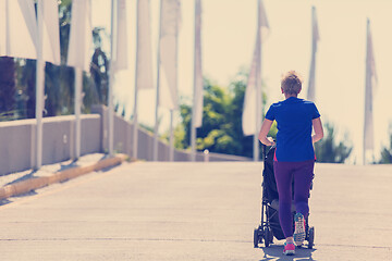 Image showing mom with baby stroller jogging