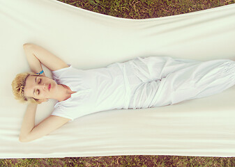 Image showing young woman resting on hammock