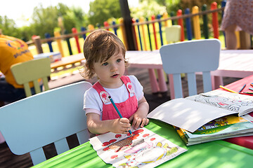 Image showing little girl drawing a colorful pictures