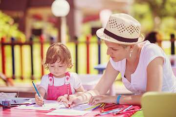 Image showing mom and little daughter drawing a colorful pictures