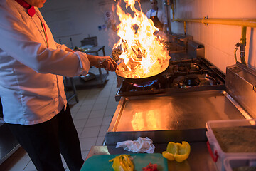 Image showing Chef doing flambe on food