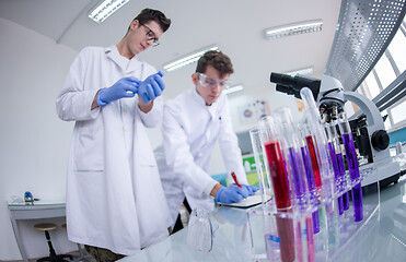 Image showing Group of young medical students doing research