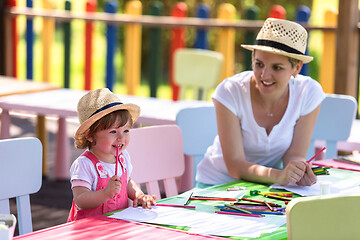 Image showing mom and little daughter drawing a colorful pictures